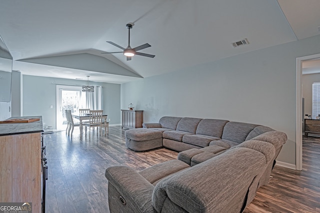 living room featuring visible vents, dark wood-type flooring, baseboards, vaulted ceiling, and a ceiling fan