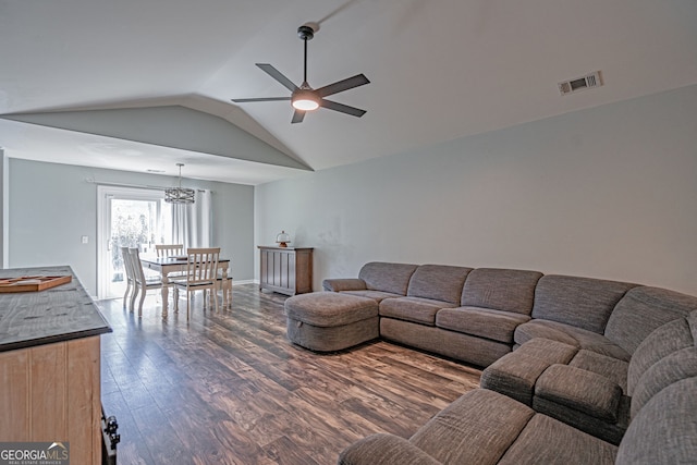 living room featuring visible vents, baseboards, lofted ceiling, dark wood-style floors, and a ceiling fan