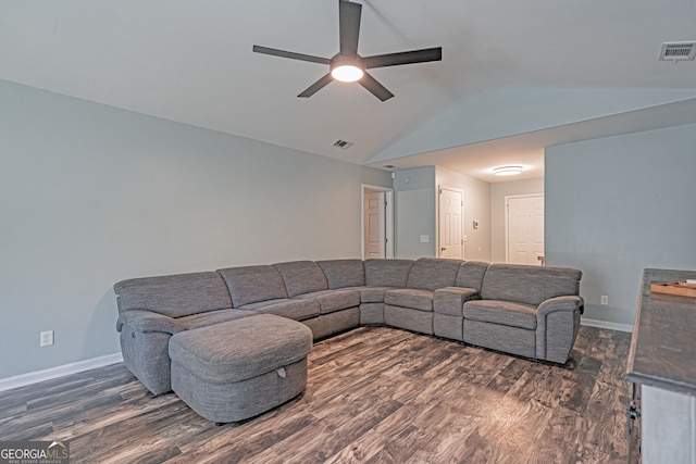 living room featuring dark wood finished floors, visible vents, and lofted ceiling