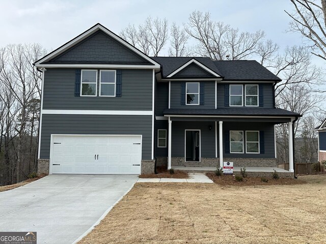 view of front facade with brick siding, covered porch, an attached garage, and concrete driveway