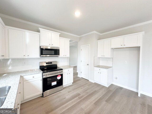 kitchen with light stone counters, light wood-style flooring, white cabinets, appliances with stainless steel finishes, and crown molding