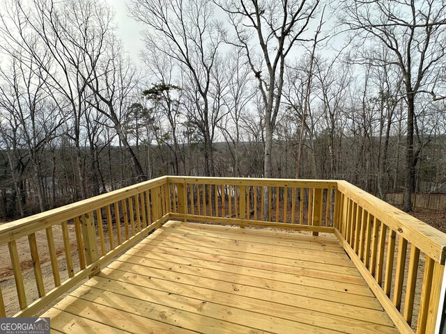 wooden deck featuring a wooded view