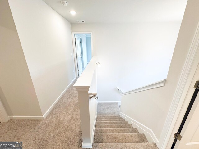 staircase featuring recessed lighting, visible vents, carpet floors, and baseboards