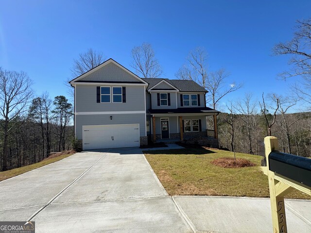 view of front facade featuring a front lawn, covered porch, concrete driveway, a garage, and brick siding