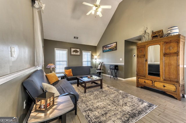 living room featuring baseboards, visible vents, light wood finished floors, and high vaulted ceiling