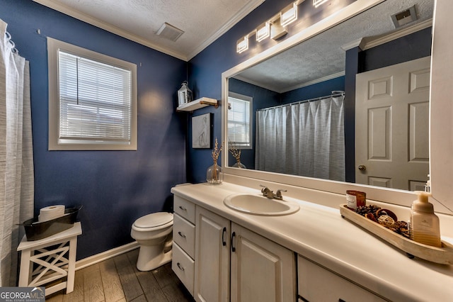 full bathroom featuring wood-type flooring, toilet, ornamental molding, and a textured ceiling