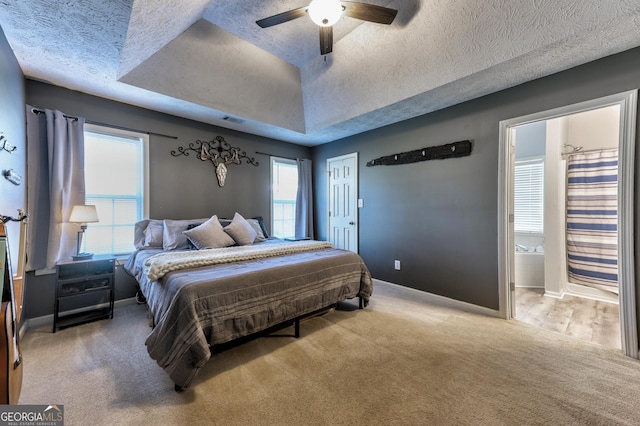 bedroom with visible vents, carpet floors, a textured ceiling, and baseboards