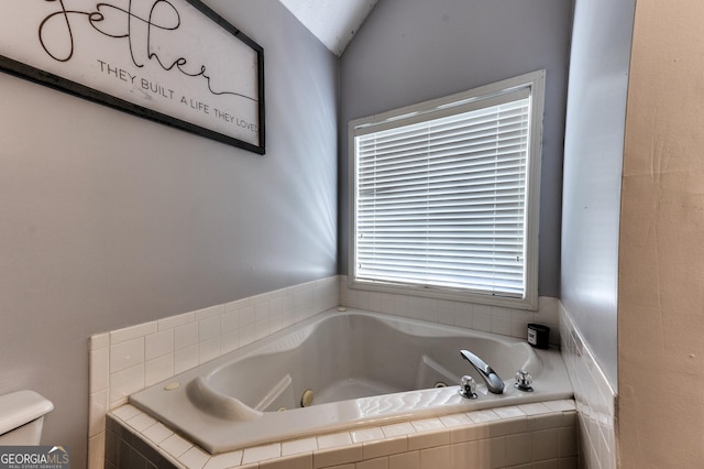 bathroom featuring toilet and a whirlpool tub