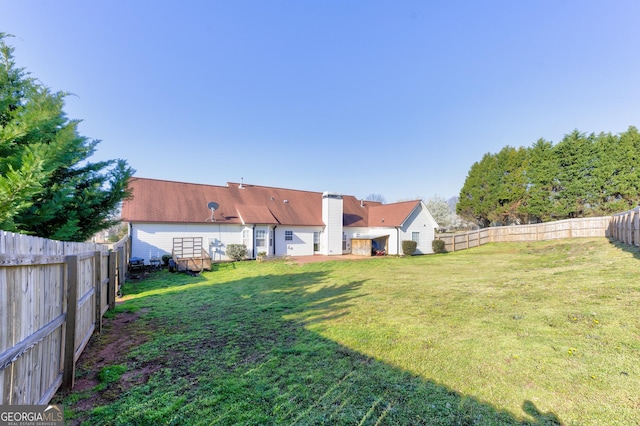 view of yard with a fenced backyard