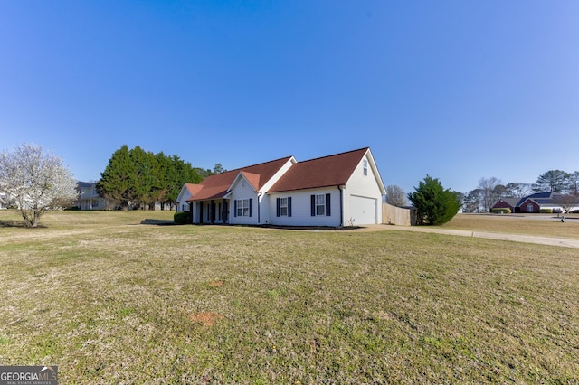 view of front of property featuring a front yard and a garage