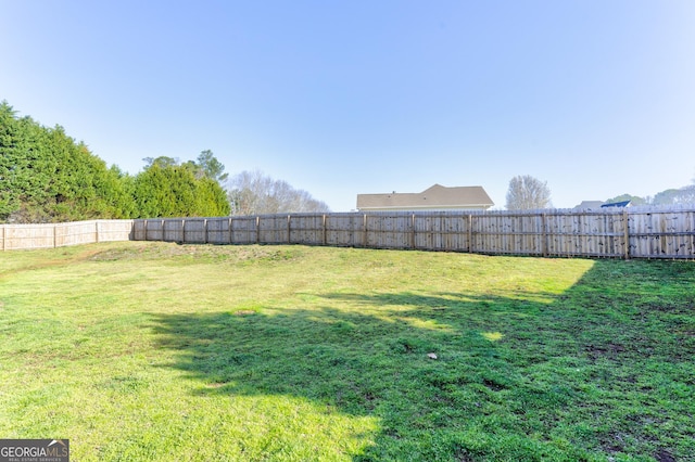 view of yard with a fenced backyard