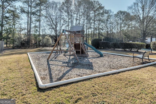 communal playground with a yard and fence