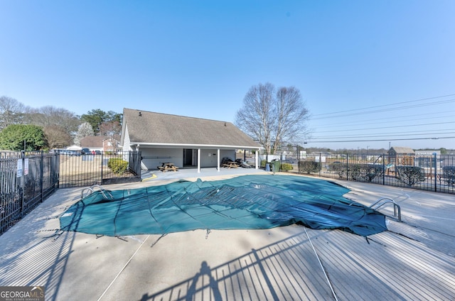 community pool featuring a patio and fence