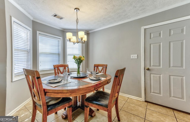 dining area featuring light tile patterned floors, visible vents, a chandelier, and crown molding