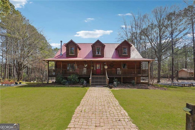 log cabin with metal roof, covered porch, and a front yard