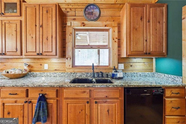 kitchen featuring a sink, light stone counters, dishwasher, and brown cabinetry