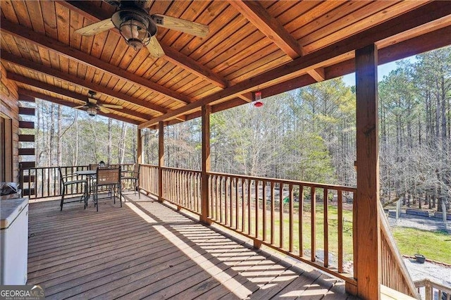 deck with outdoor dining area and ceiling fan