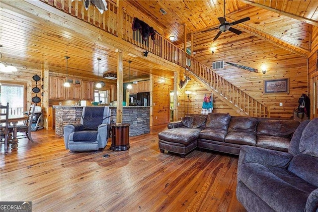 living room featuring stairway, wood ceiling, and light wood-style flooring