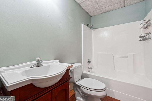 bathroom with vanity, toilet, a paneled ceiling, and shower / bath combination