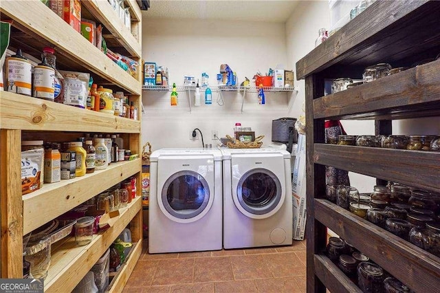 clothes washing area with laundry area and washer and clothes dryer