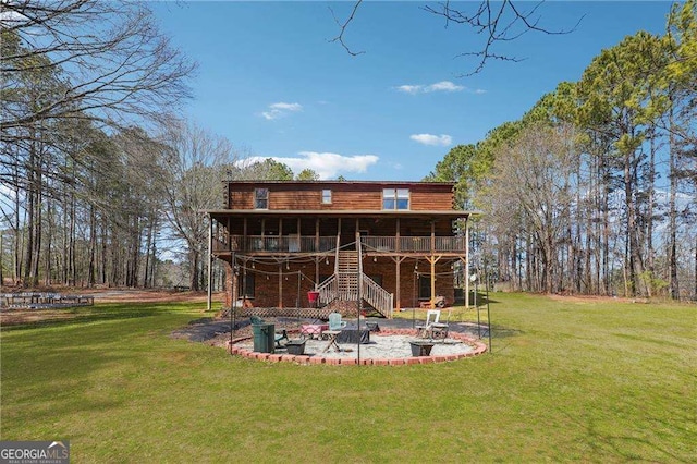 view of yard with a patio area, a wooden deck, and stairs