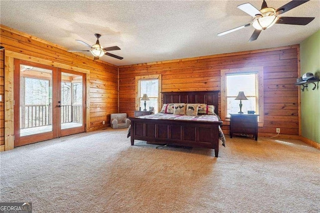 bedroom with carpet flooring, access to exterior, multiple windows, and french doors