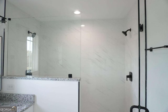 bathroom featuring vanity and a tile shower