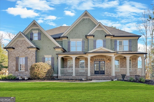 view of front of property with brick siding, a porch, and a front lawn