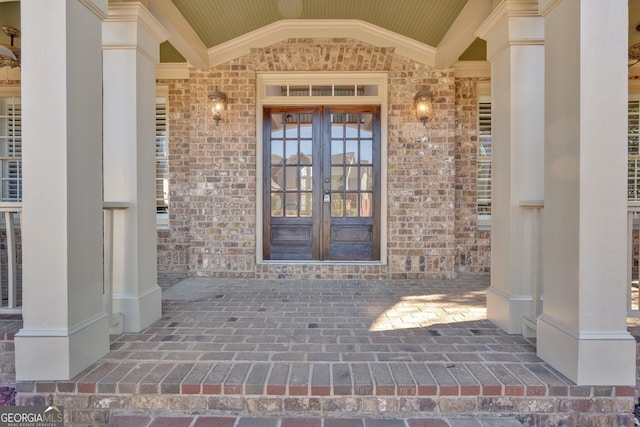 doorway to property with brick siding and french doors