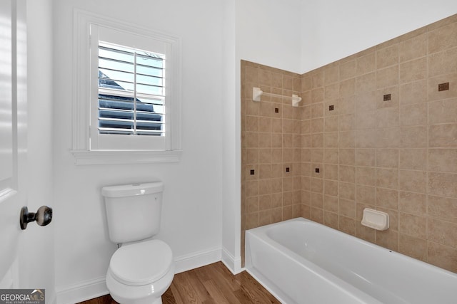 full bath with baseboards, toilet, and wood finished floors