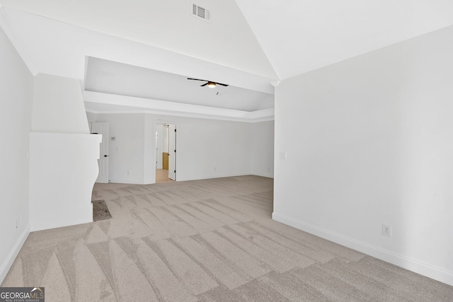 spare room featuring baseboards, visible vents, carpet floors, lofted ceiling, and ceiling fan