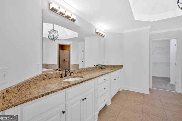 full bath with a sink, a stall shower, ornamental molding, and tile patterned floors