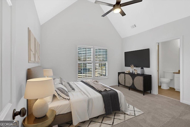 bedroom with visible vents, light carpet, high vaulted ceiling, a ceiling fan, and connected bathroom