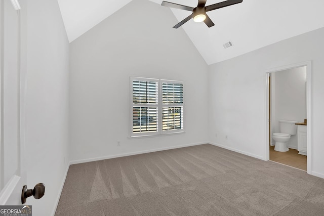 unfurnished bedroom featuring visible vents, high vaulted ceiling, connected bathroom, carpet floors, and baseboards