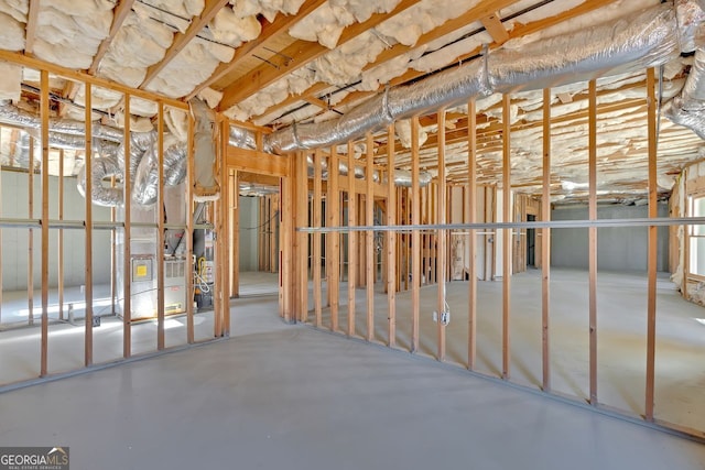 misc room with water heater and concrete floors