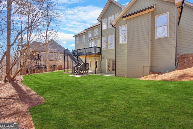 back of property with stairway, a yard, a deck, and a patio area