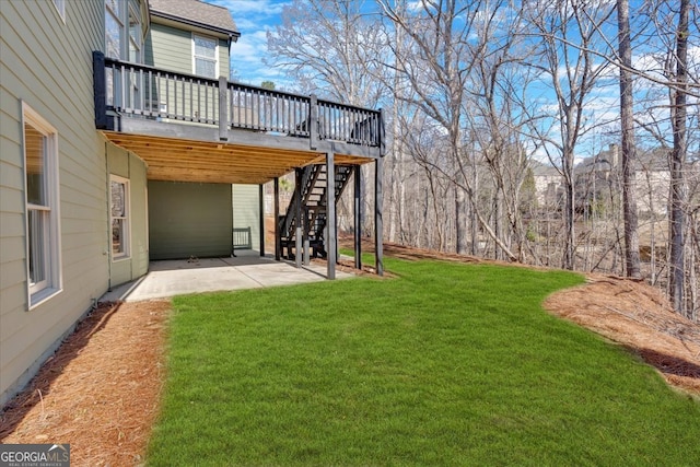 view of yard featuring stairs, a patio, and a wooden deck