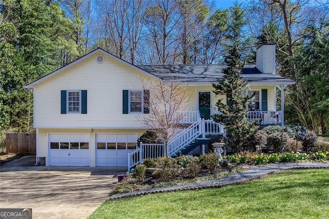 view of front of home with stairway, driveway, covered porch, a chimney, and a garage