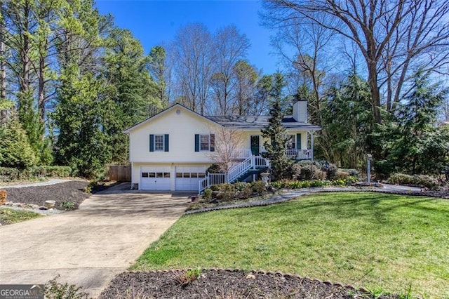 view of front of property with a front yard, a chimney, stairs, concrete driveway, and a garage