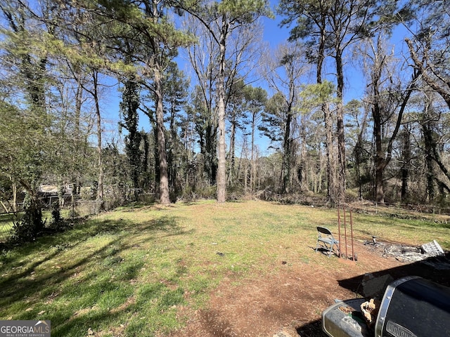 view of yard featuring a forest view