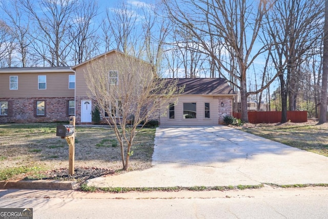 view of front of home featuring brick siding and driveway