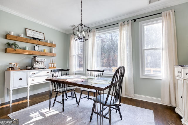 dining room with visible vents, dark wood-style floors, crown molding, baseboards, and a chandelier