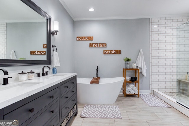 bathroom with a shower stall, ornamental molding, double vanity, and a sink