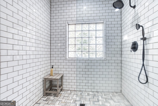 bathroom with tiled shower