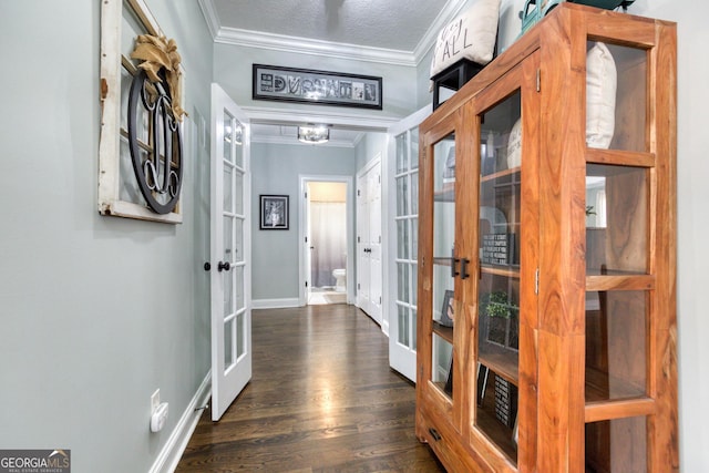 hallway featuring french doors, dark wood-type flooring, and crown molding