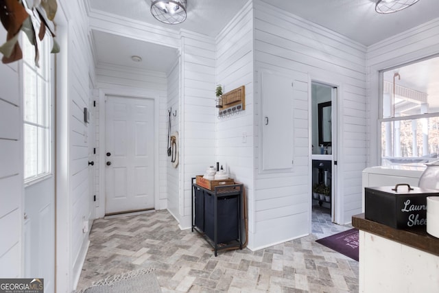 interior space featuring brick floor, plenty of natural light, wooden walls, and ornamental molding