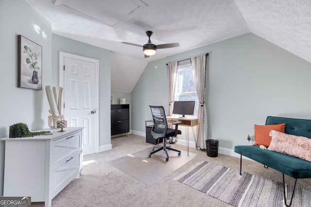 office space featuring light carpet, a textured ceiling, and vaulted ceiling