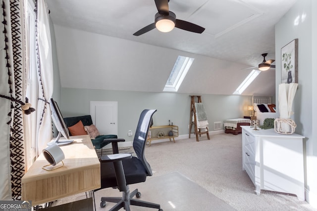 home office with visible vents, baseboards, lofted ceiling, ceiling fan, and light colored carpet