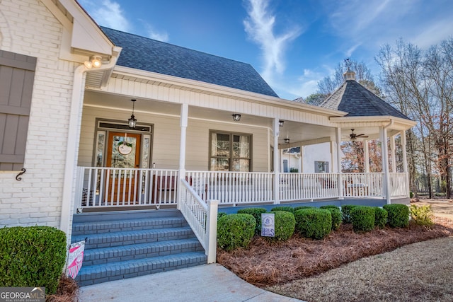 property entrance featuring brick siding, covered porch, and a shingled roof