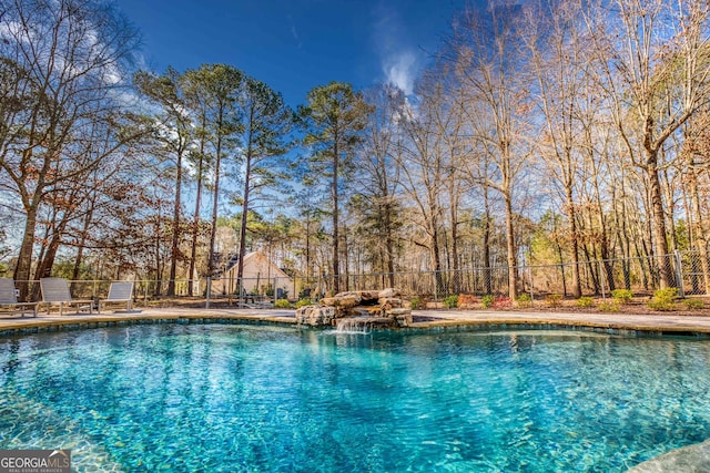 view of pool featuring a fenced in pool and fence